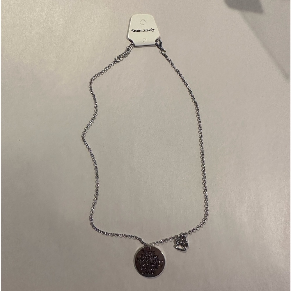 Silver tone necklace says Dogs aren’t my whole life. They make my life whole